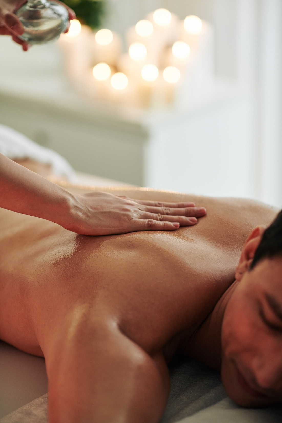 Masseuse Pouring Massage Oil